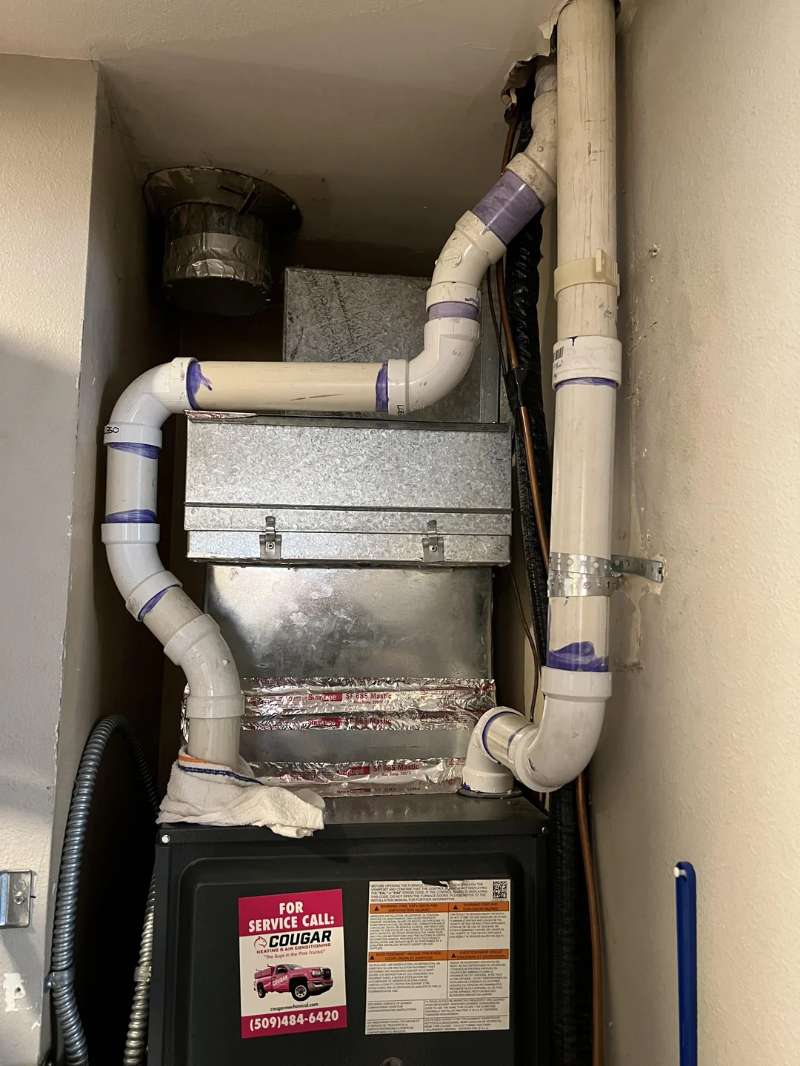 LGQF-LL 2-inch 0-degree stainless steel vent screen installed on a white PVC furnace intake pipe to prevent rainwater infiltration and motor damage.
