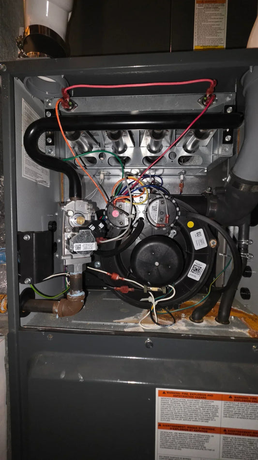 Diagram showing a high-efficiency Goodman furnace with PVC intake and exhaust pipes, illustrating common blockage points like bird nests or ice buildup for HVAC airflow troubleshooting.
